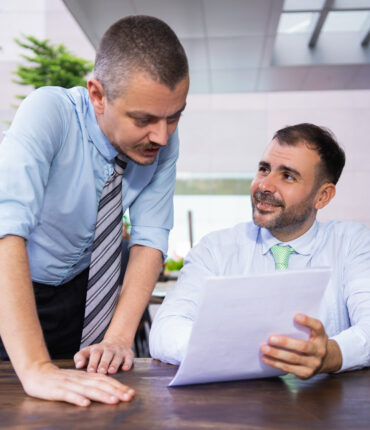 cheerful-successful-business-colleagues-discussing-documents cheerful-successful-business-colleagues-discussing-documents